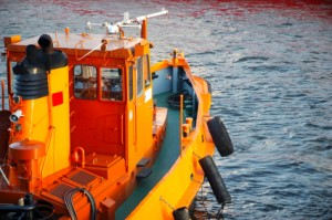 Orange tugboat wating in the harbor